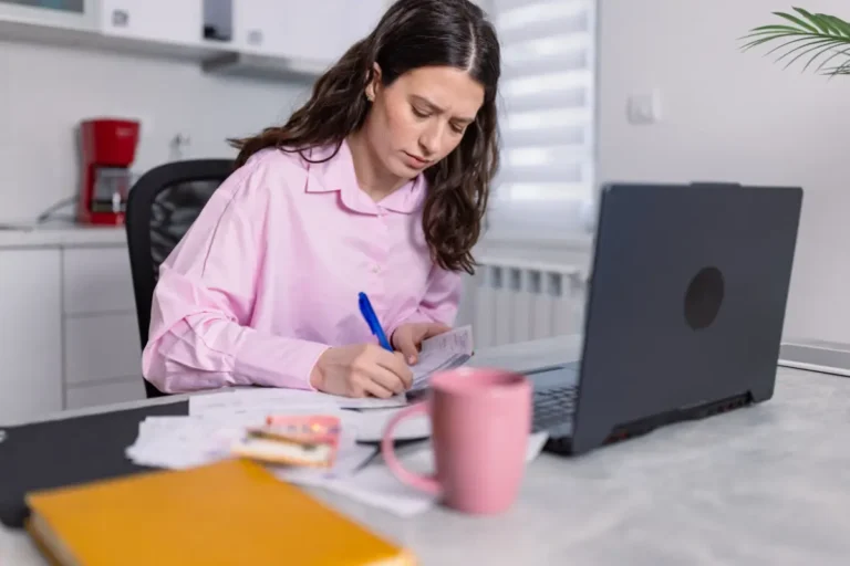 A woman working on a laptop at home, symbolizing unmatched flexibility and convenience for work or study